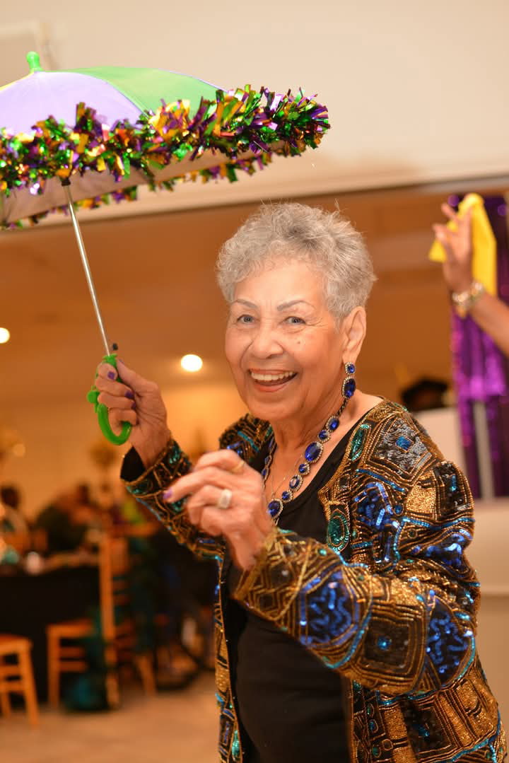 Joyful guest dancing with a parasol