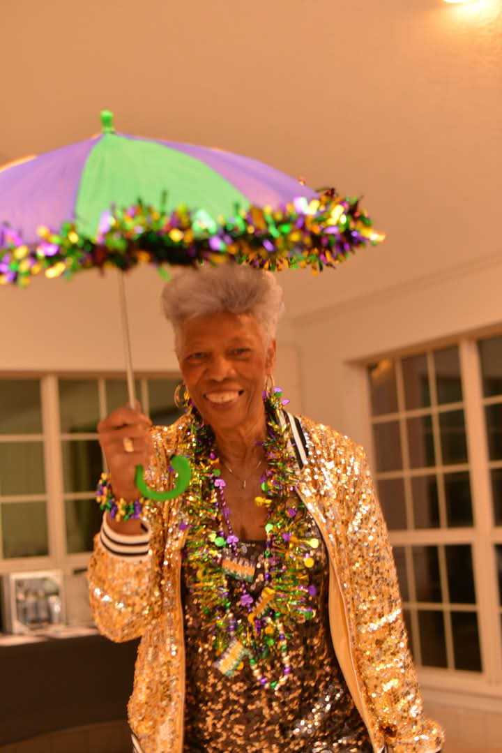 Guest with a Mardi Gras parasol